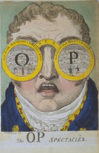A caricature of John Philip Kemble (1757-1823) showing a portrait of a man wearing large spectacles with the letters 'OP' on each lens with theatrical scenes behind. The inscription on the left frame is 'Old House, Old Prices & No Private Boxes'; on the right frame is 'Old House, Old Prices & No Pigeon Holes'.