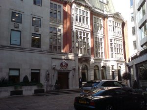 Grocers' Hall, Prince's Street Grocers' Hall is the home of the Worshipful Company of Grocers, which ranks second of the City Livery Companies and was originally known as The Guild of Pepperers. Their earliest records date from the year 1180. Grocer's Hall is hidden in a court off Prince's St, and is easy to miss, as larger buildings surround it and entry to this court is through alleys under these buildings. The current building is the 5th Grocers' Hall and was completed in 1970 to replace the previous building which was destroyed by fire on 22nd Sept 1965. See the Grocers Company website http://www.grocershall.co.uk/