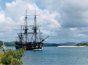 Endeavour replica in Cooktown, Queensland harbour — anchored where the original Endeavour was beached for seven weeks in 1770. (Uploaded by John Hill. In public domain.)